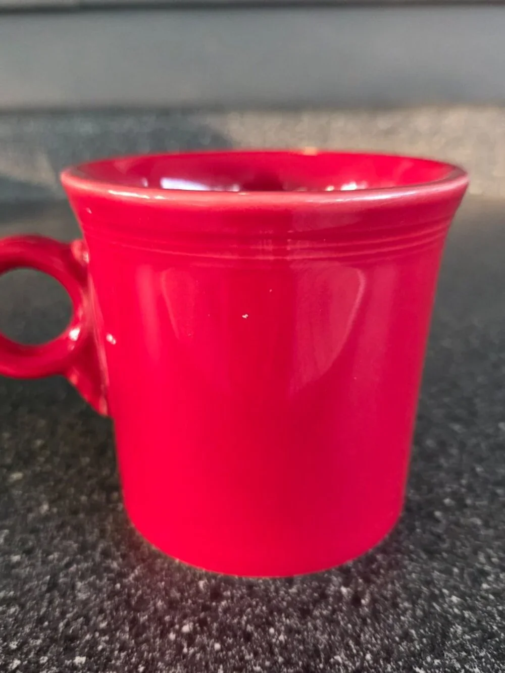 Fiestaware ceramic mugs in black and red with a ring handle, 10.25 oz capacity.